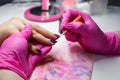 Manicure nail paint, Closeup shot of a woman in a nail salon receiving a manicure by a beautician Royalty Free Stock Photo