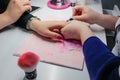 Manicure nail paint, Closeup shot of a woman in a nail salon receiving a manicure by a beautician Royalty Free Stock Photo