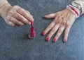 Manicure. Old Woman Hands Polishing Nails With Red Nail Polish In Beauty Salon Royalty Free Stock Photo