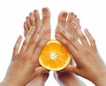 Manicure pedicure on afro-american tann skin hands holding orange, healthcare concept Royalty Free Stock Photo