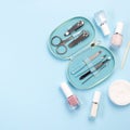 Manicure or pedicure set equipment with nail coat or polish, on blue background, copy space, top view, square Royalty Free Stock Photo