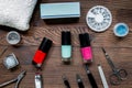 Manicure preparation set with nail polish bottles on wooden background top view