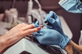 Closeup hands. Manicure procedure in progress - Beautician master applying color nail polish. Royalty Free Stock Photo