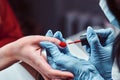 Closeup hands. Manicure procedure in progress - Beautician master applying color nail polish. Royalty Free Stock Photo