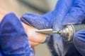 Manicure process, cleaning nails with a milling cutter close up
