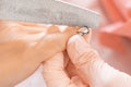 Manicure salon woman receiving a manicure by a beautician with nail file. Woman getting nail manicure. Professional Royalty Free Stock Photo