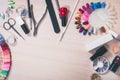 Manicure set and nail polish on wooden background