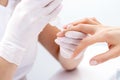 Manicurist`s hands applying glue for nails