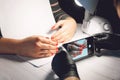 Manicure specialist in black gloves takes pictures of hands with red nails by phone. Manicurist in beauty salon. How shoot nail Royalty Free Stock Photo