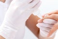 Manicure specialist`s hands applying glue for nail Royalty Free Stock Photo