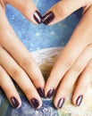 manicure stylish concept: woman fingers with nails purple glitter on nails like cosmos, universe background Royalty Free Stock Photo