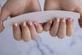 Manicure tools Woman manicured hands, stylish summer colorful nails. Closeup of manicured nails of female hand. Summer