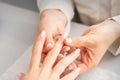 Manicure treatment at beauty spa. A hand of a woman getting a finger massage with oil in a nail salon. Royalty Free Stock Photo