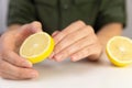 Manicure, woman cleans her nails with lemon.