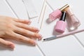 Manicure. A woman glues stickers on her nails for French manicure. The girl applies nail Polish. Nail care. Nail salon, procedure Royalty Free Stock Photo