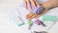 Manicure. The woman wipes her hand with a towel. Manicure tools, nail polishes. Home nail care, SPA, beauty. Long natural nails. Royalty Free Stock Photo