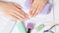 Manicure. Women`s hands on a towel. Manicure tools, nail Polish. Home nail care, SPA, beauty. Long natural nails. Beauty salon