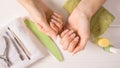 Manicure. Women`s hands on a towel. Manicure tools, nail Polish. Home nail care, SPA, beauty. Long natural nails. Beauty salon Royalty Free Stock Photo