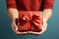 Manicured gesture Womans hands delicately hold a red gift