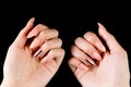 Young girl shows manicured hands on a black background. Pink coral nails Royalty Free Stock Photo