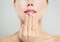 Manicured hand with french manicure and pink glossy lips. Woman face macro