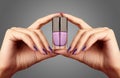 Manicured nails with lilac nail polish. Manicure with bright nailpolish. Fashion manicure. Shiny gel lacquer in bottle Royalty Free Stock Photo