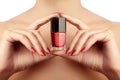 Manicured nails with red nail polish. Manicure with bright nailpolish. Fashion manicure. Shiny gel lacquer in bottle