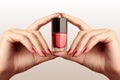 Manicured nails with red nail polish. Manicure with bright nailpolish. Fashion manicure. Shiny gel lacquer in bottle Royalty Free Stock Photo