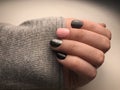 Manicured nails with sweater sleeve