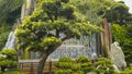 Tree and a man made waterfall at nan lian gardens in hong kong