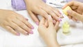 The manicurist applies a moisturizing oil to the cuticle. SPA manicure, procedure, moisturizing. Skin care. Beauty salon. Manicure