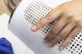 The manicurist applies nail base with a brush to the nails covered with primer.