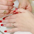 Manicurist applying red nail