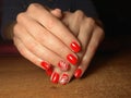 The manicurist excellently made her work a beautiful manicure with a polish gel on her hands and the client is happy