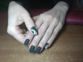 The manicurist excellently made her work a beautiful manicure with a polish gel on her hands and the client is happy