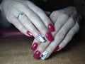 The manicurist excellently made her work a beautiful manicure with a polish gel on her hands and the client is happy