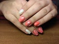 The manicurist excellently made her work a beautiful manicure with a polish gel on her hands and the client is happy