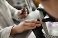 Manicurist filing client`s nails in beauty salon, closeup