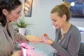 manicurist filing nails young woman