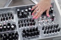 Manicurist hand showing set nail polishes bottles for clients of beauty manicure salon Royalty Free Stock Photo