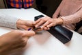 Manicurist make manicure client in nail salon