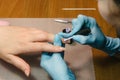 Manicurist makes hardware manicure close-up. Treatment of nails with the help of hardware manicure Royalty Free Stock Photo