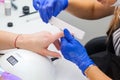 Manicurist makes the procedure a woman in nail salon