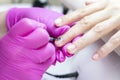 manicurist in pink gloves manicures a girl Royalty Free Stock Photo