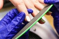 a manicurist removes an old manicure