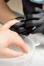 Manicurist removing cuticle from nails Royalty Free Stock Photo