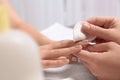 Manicurist removing polish from client`s nails in salon Royalty Free Stock Photo