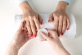 Manicurist removing polish from client`s nails on white background Royalty Free Stock Photo