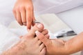 Manicurist With Scissors Trimming Person`s Toenail Royalty Free Stock Photo