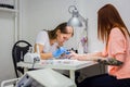 Manicurist treating client at beauty salon - painting on the nail Royalty Free Stock Photo